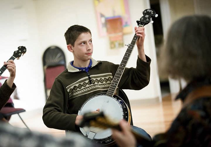 Boy plays banjo