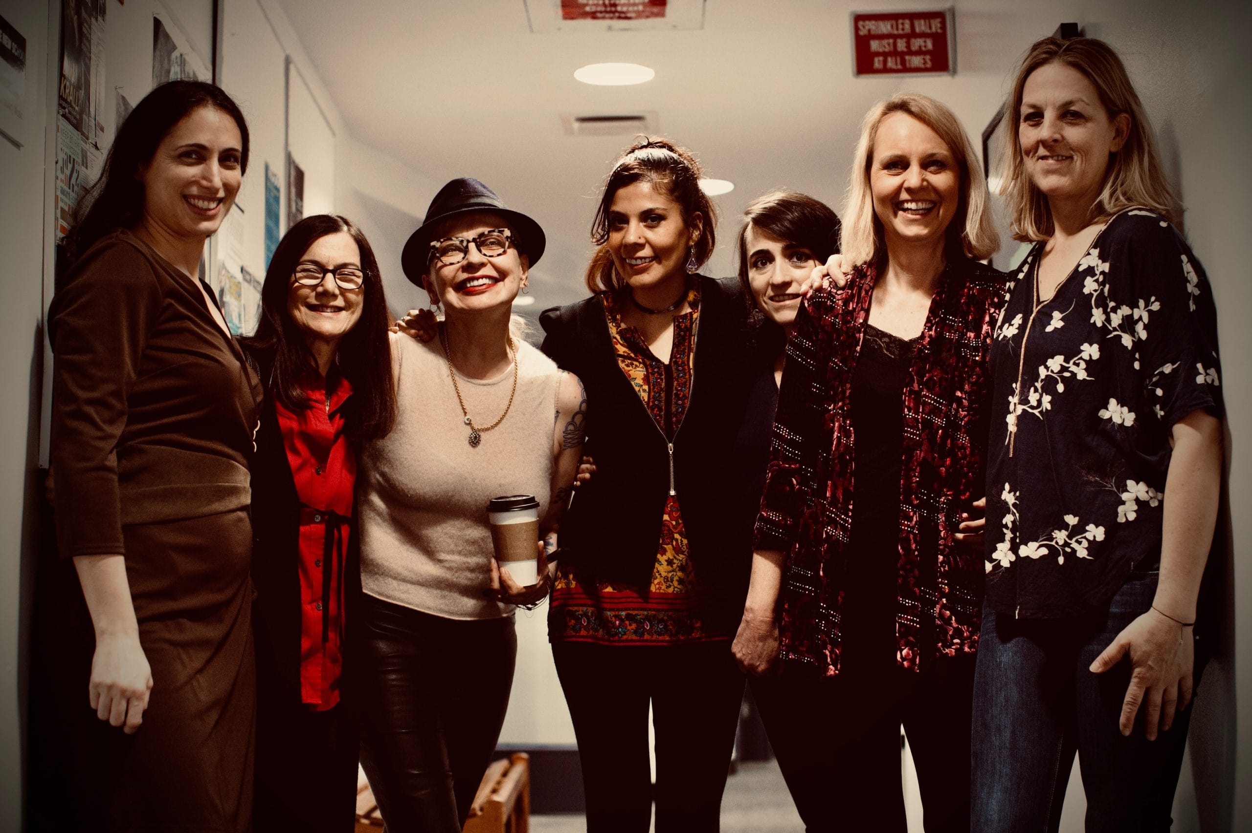 Group of women musicians standing together smiling.