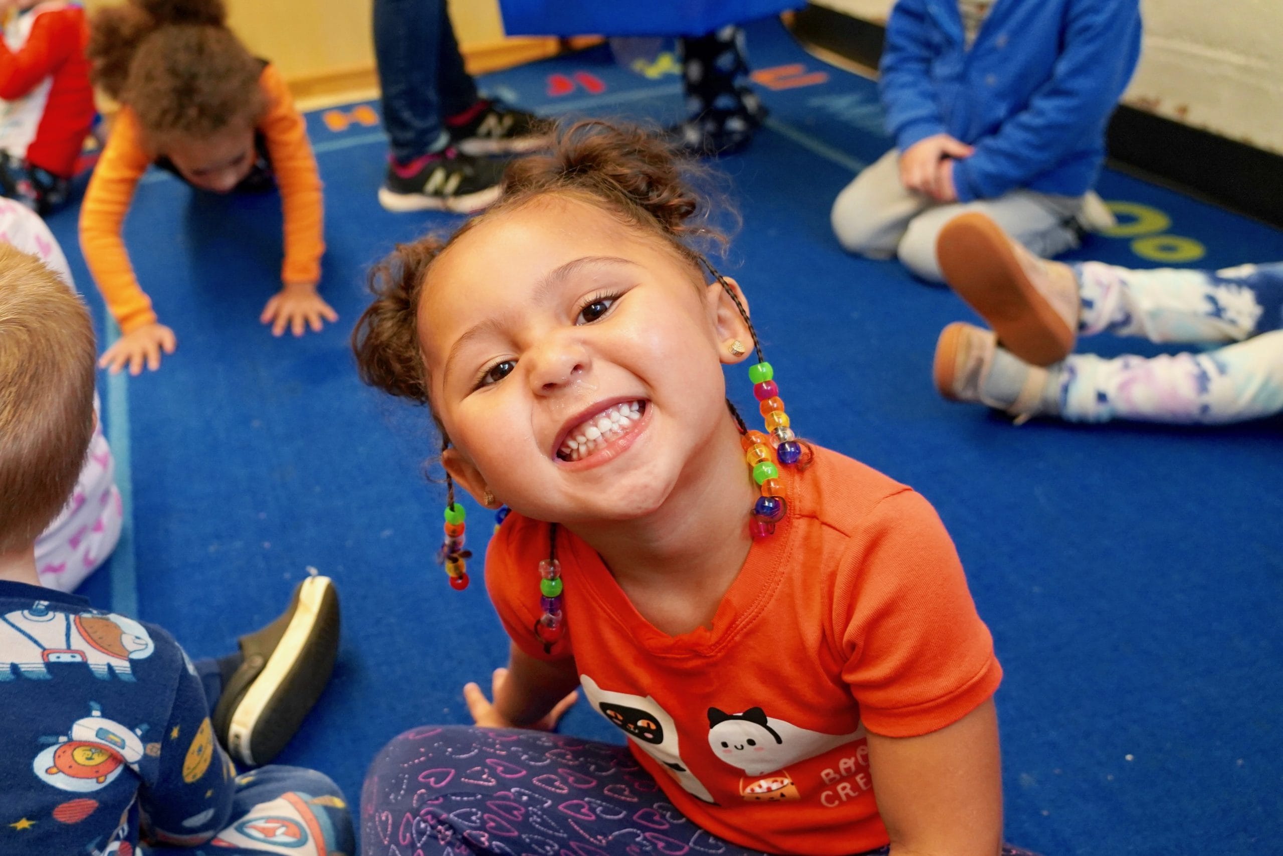 4 year old girl smiling during music class