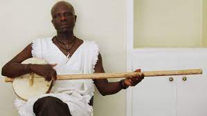 A Gambian man plays the Akonting